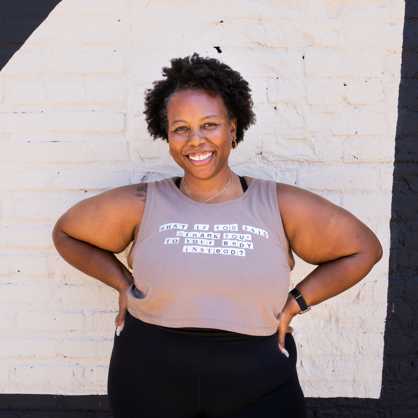 woman wearing dusty rose colored crop tank with the phrase: what if you said thank you to your body instead