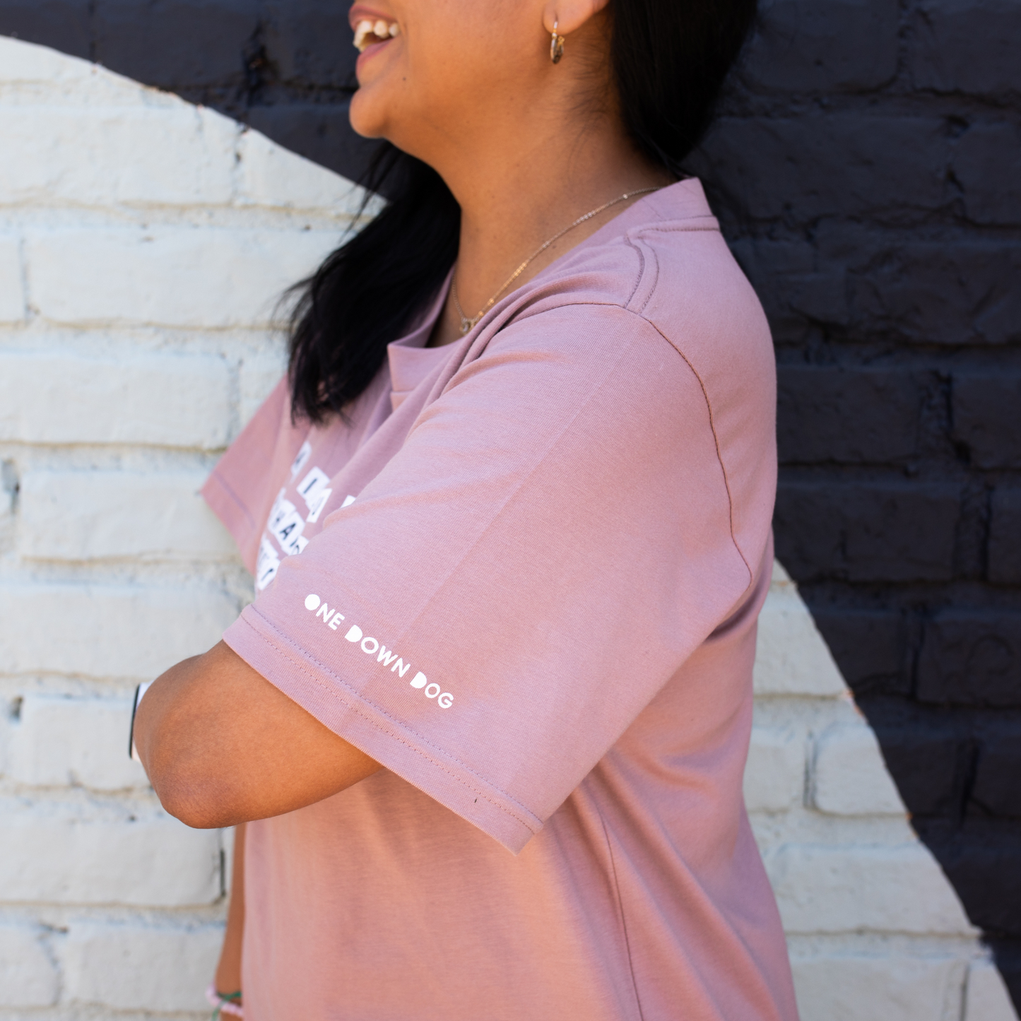 close up of side of sleeve of unisex tee with the words one down dog