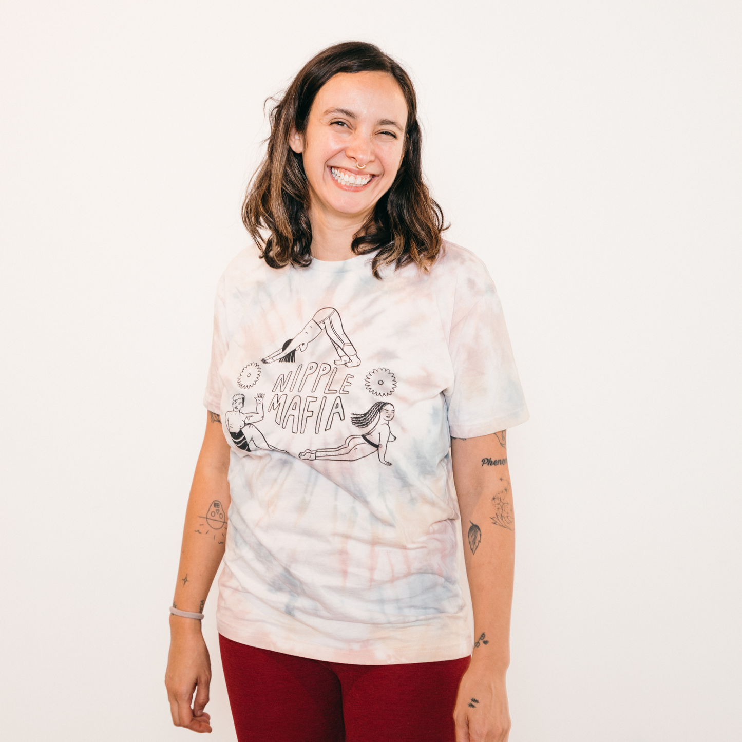tie-dye tee with design of people doing three different poses with the phrase nipple mafia in the middle