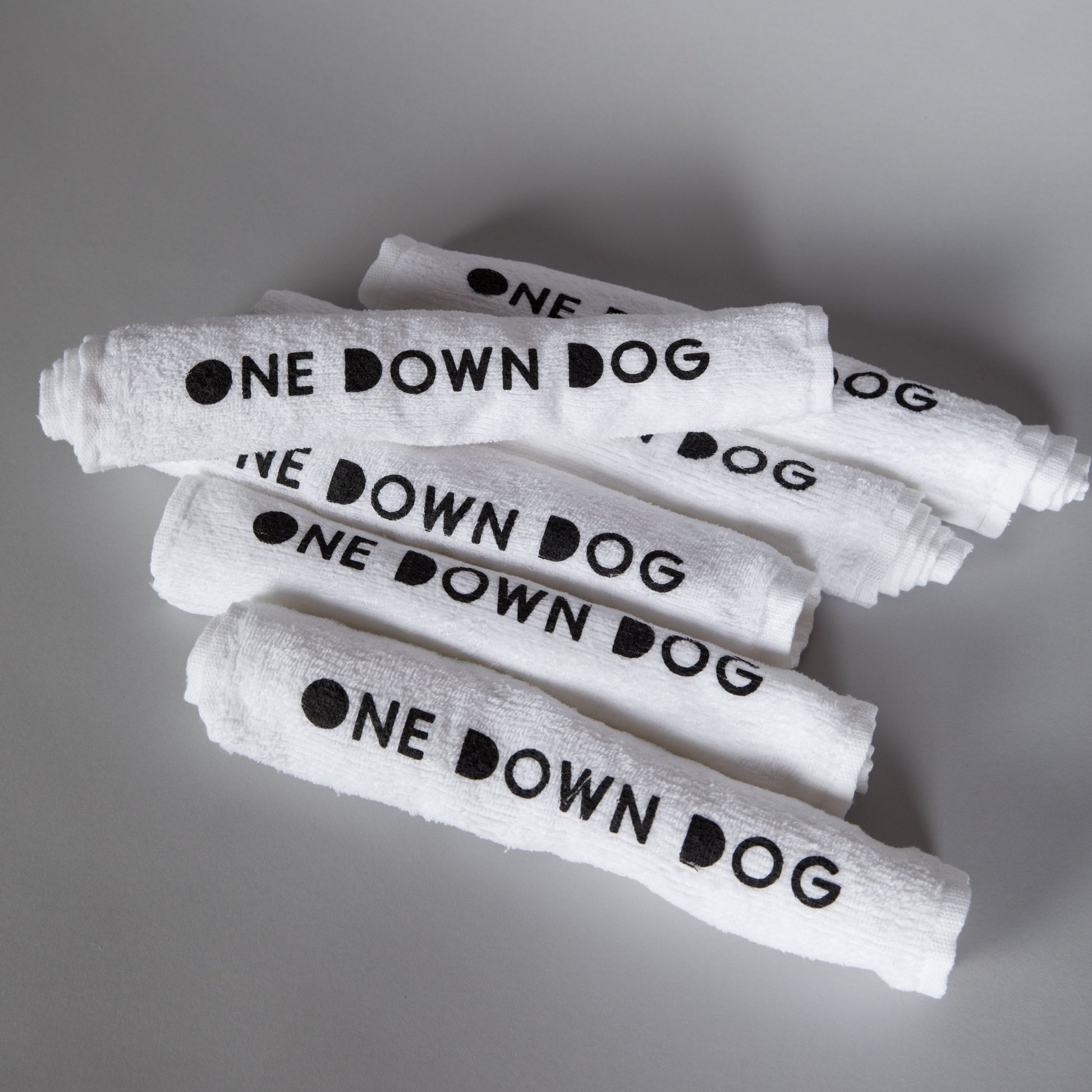 white hand towel with One Down Dog logo
