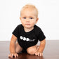 Baby crawling in black onesie with words ODD baby in white