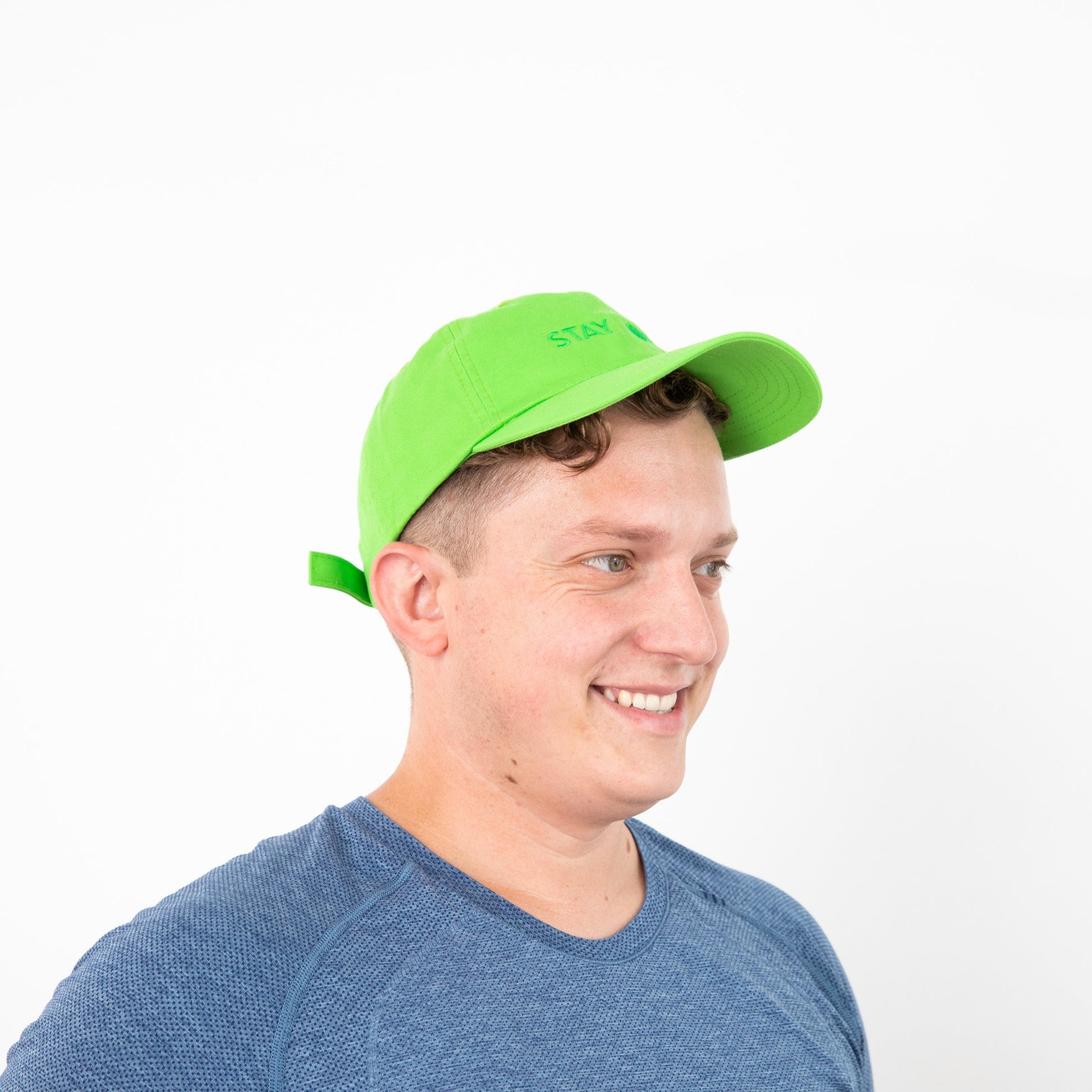 Side view of person wearing neon green baseball cap