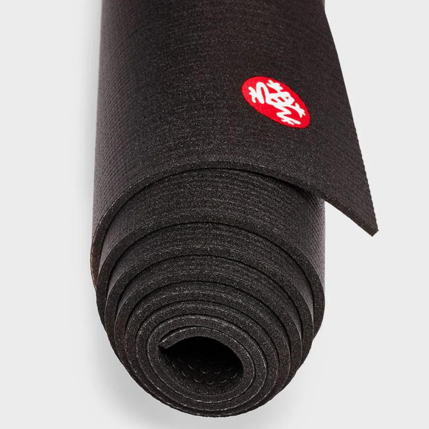 close up black manduka prolite yoga mat rolled up