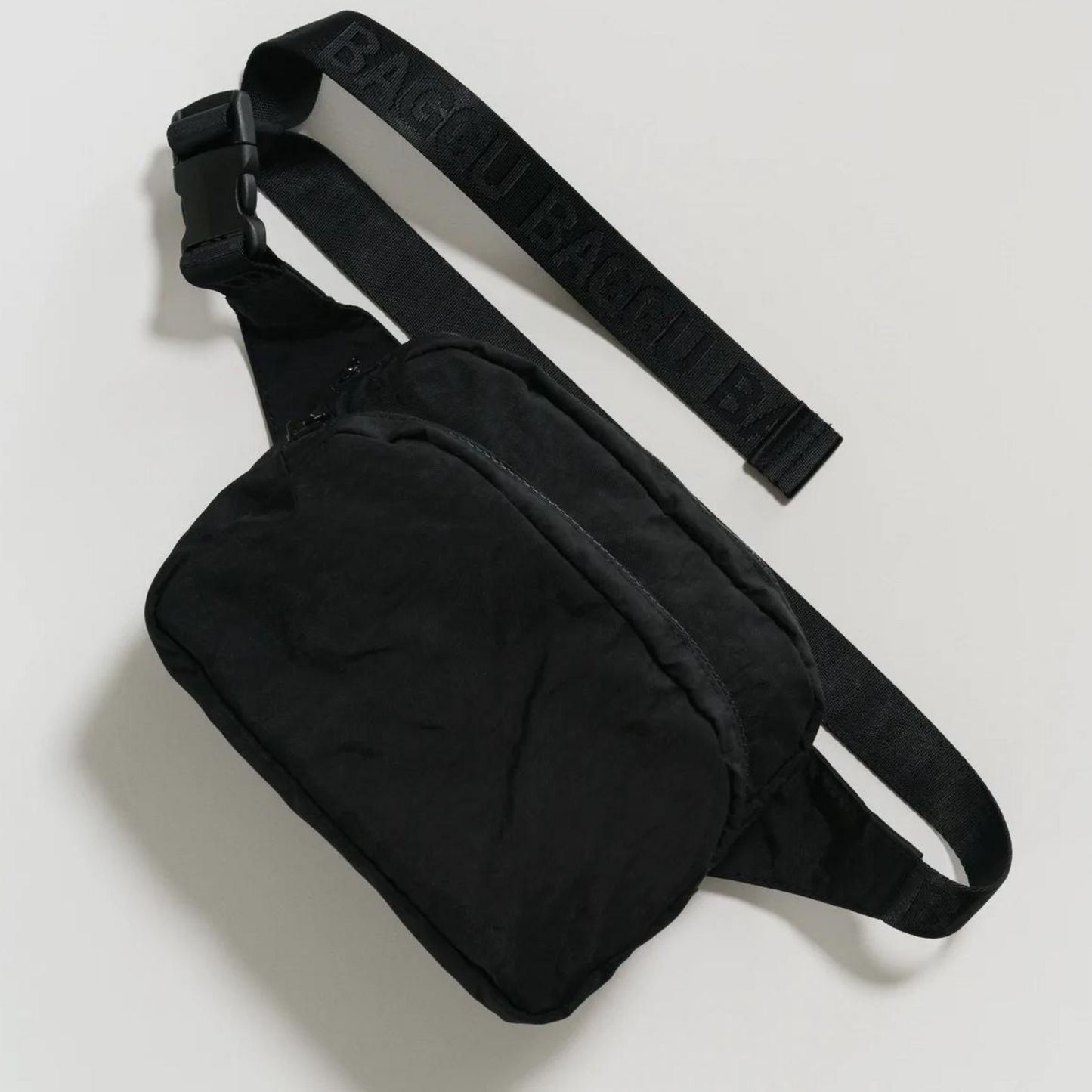 black fanny pack with two black zippers and a thick black strap and buckle