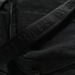 close up of black fanny pack strap that reads BAGGU