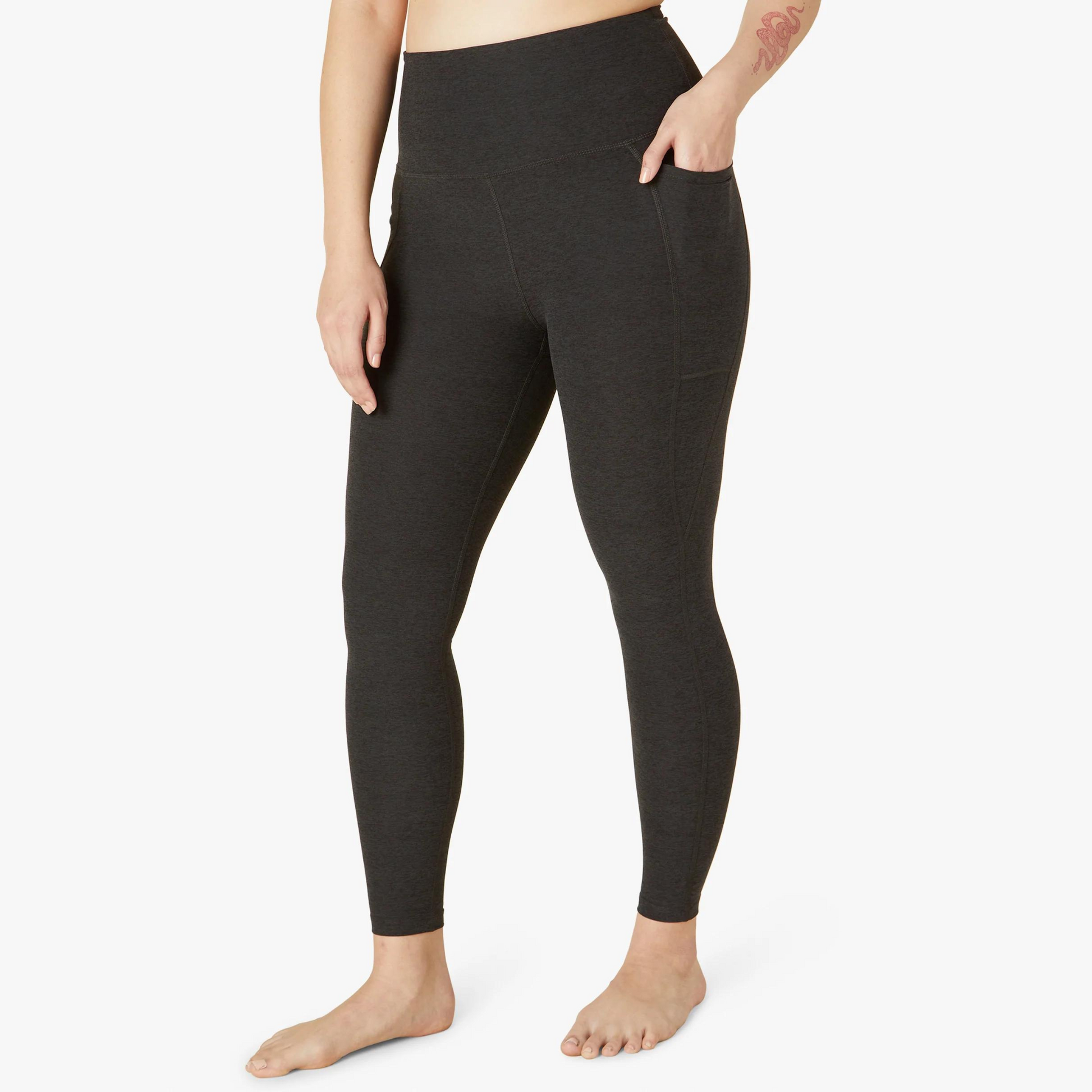 front of dark charcoal midi length legging with hand in pocket