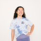 blue tie-dye unisex t-shirt tucked into leggings with the phrase one down dog in black print