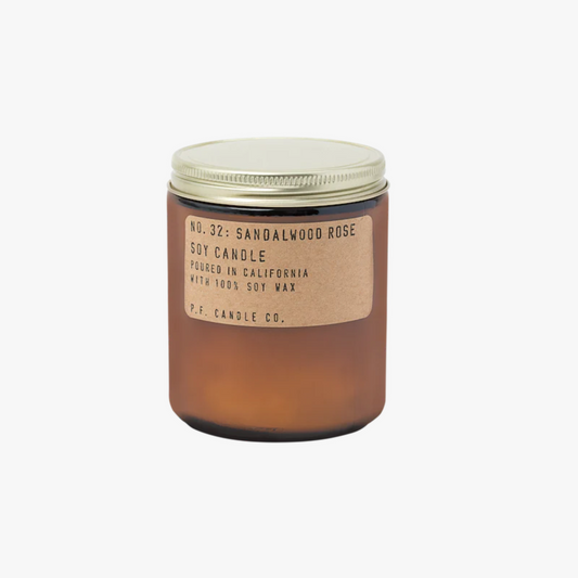 amber glass candle jar with gold lid and brown label that reads: No. 32: Sandalwood Rose Soy Candle Poured in California with 100% Soy Wax P.F. Candle Co