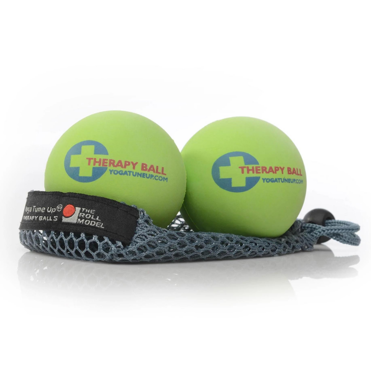 two lime green therapy balls that read "Therapy Ball yogatuneup.com" sitting on a grey mess carrying bag