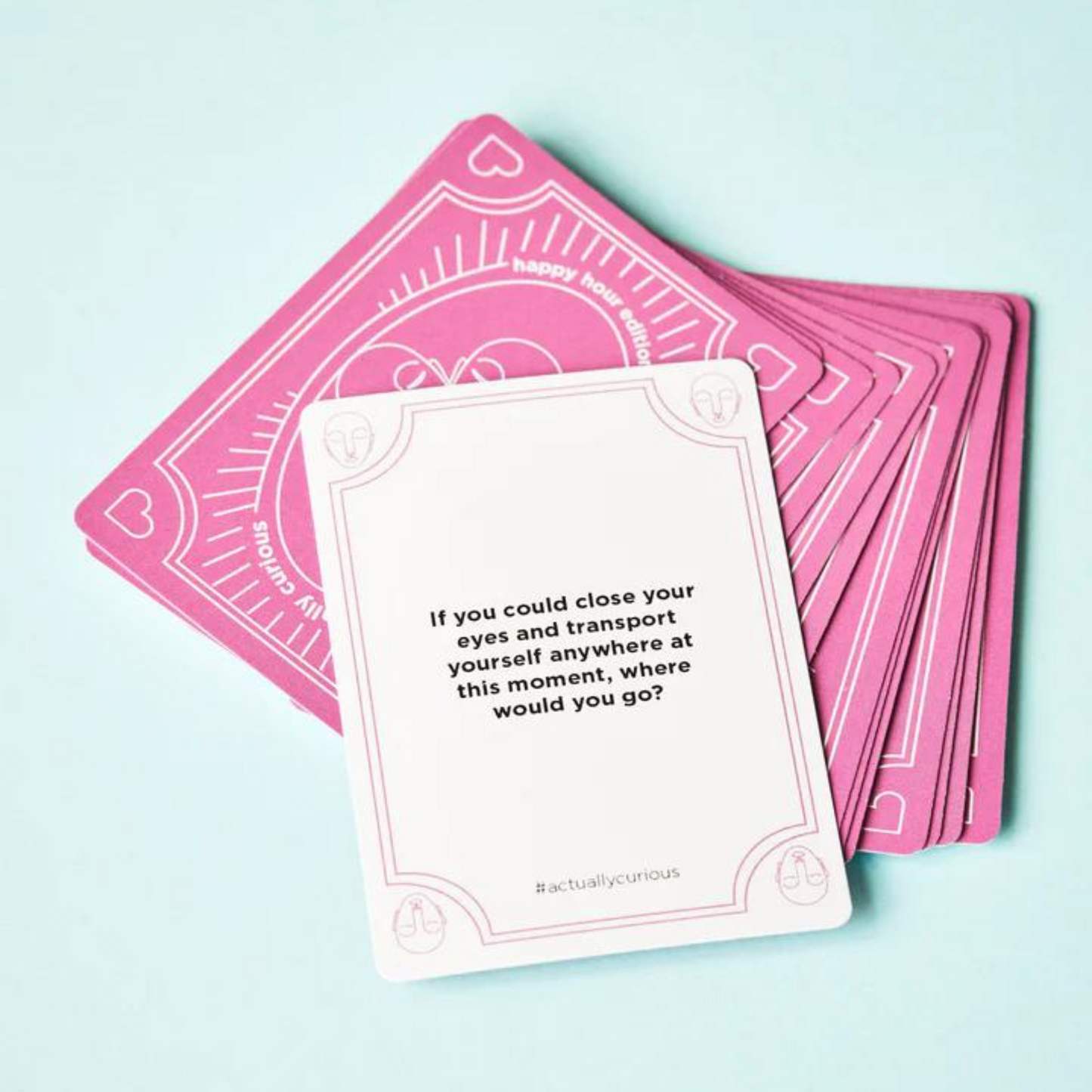 deck of cards with top card displayed with "If you could close your eyes and transport yourself anywhere at this moment, where would you go?" written on it