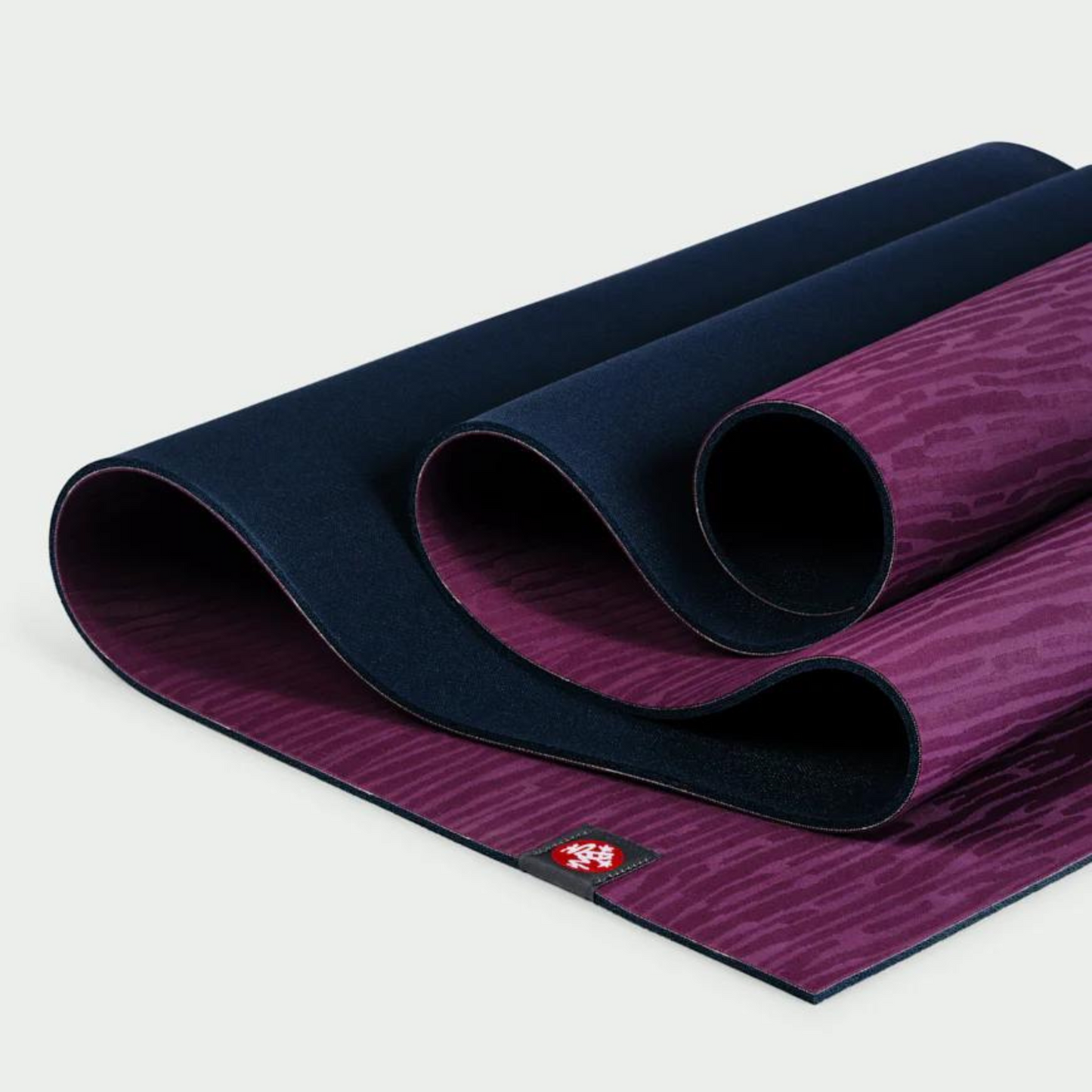 dark purple manduka eko lite yoga mat folded over