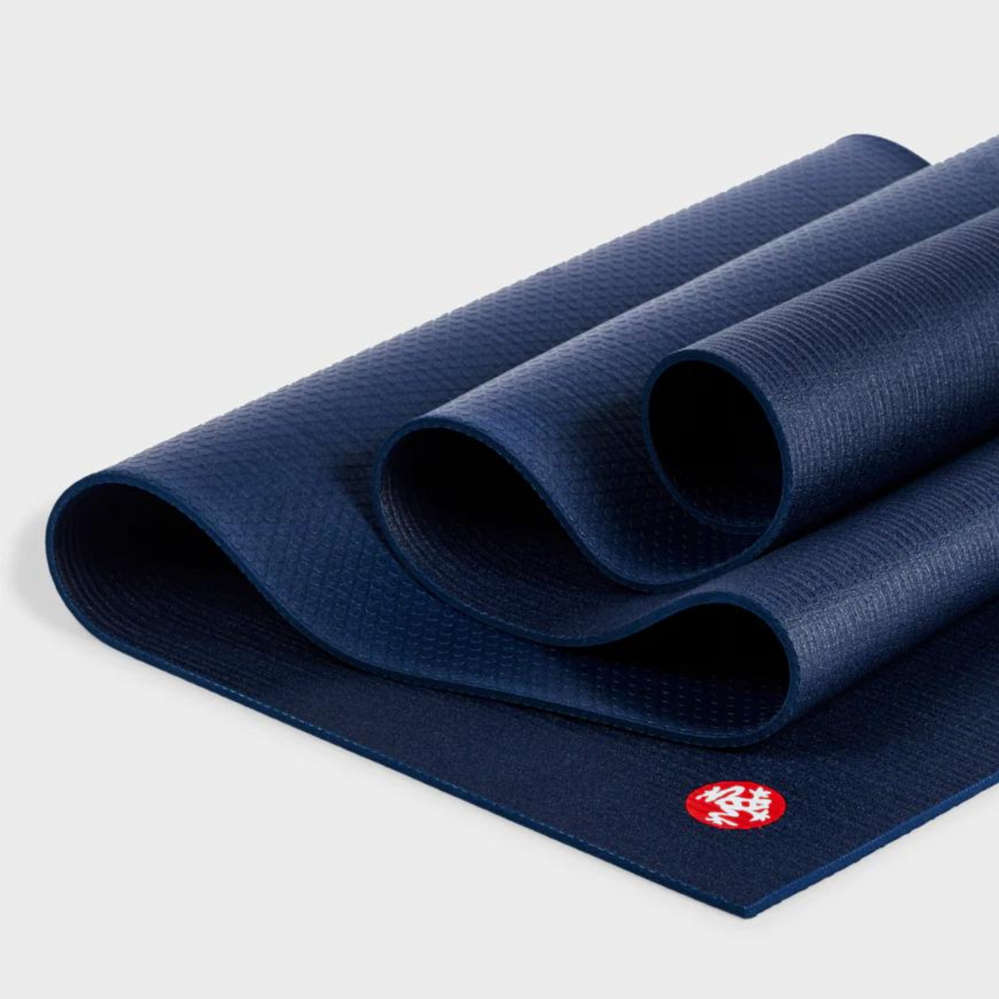 dark navy manduka pro lite yoga mat folded over