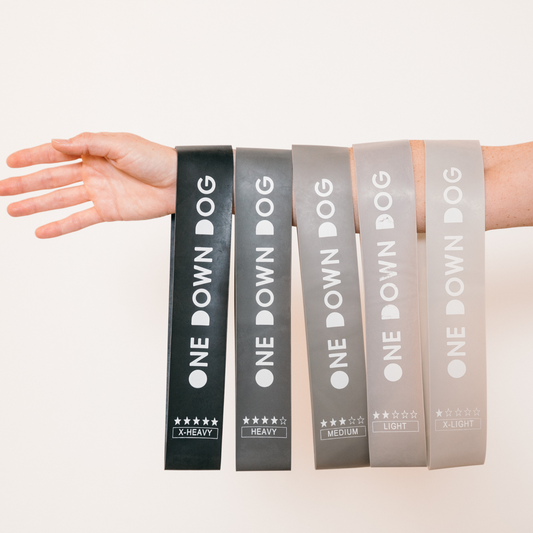 five ombre grey resistance bands hung on arm